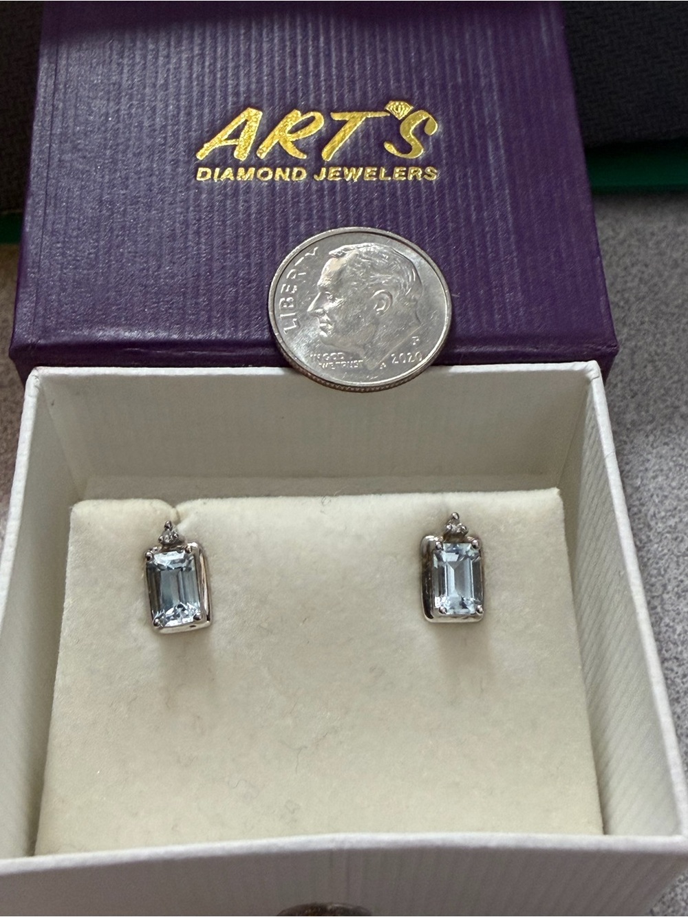 10K White Gold and Aquamarine Stud Earrings with a diamond chip